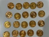 a lot of gold coins that are on the table
