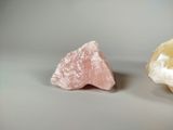 two pieces of pink and white rock on a table