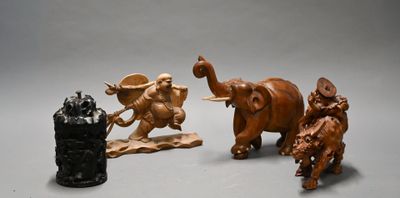 three figurines of elephants and a lion on a table