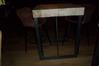 a small table with two stools in the middle of the room