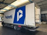 a delivery truck that is parked in a warehouse