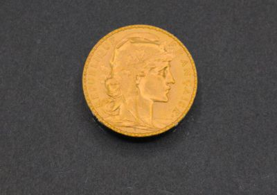 a close up of a gold coin on a black surface