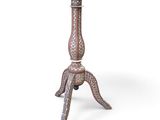 an ornately decorated table with a wooden top and metal legs