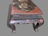 a small table with a painting on top of it