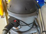 a vacuum that is sitting on the floor in the garage