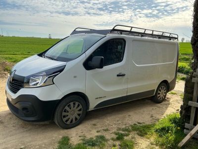 a white van parked on the side of a dirt road