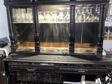 a black bar with a wine rack in the middle of it