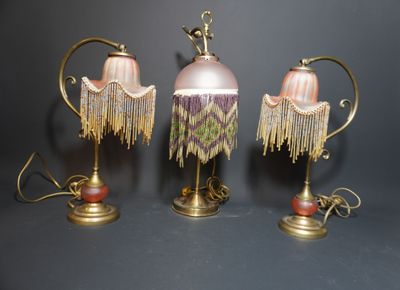 trois lampes ornées de franges, posées sur une table