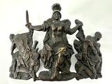 a statue of a woman holding a sword next to a group of people