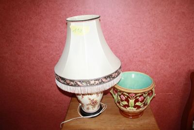 a lamp that is sitting on a table next to a bowl