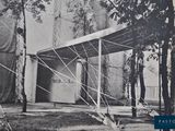 a picture of an old photo of a house in the woods