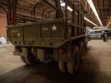 a military truck that is parked inside of a building