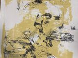 yellow and black abstract painting on white paper on a wooden table