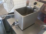 a deep fryer sitting on a counter in a kitchen