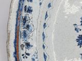 a blue and white plate with a design on it