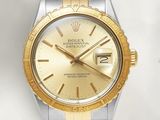 an image of a gold and silver rolex watch on a white background