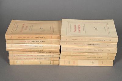 several books are stacked on top of each other on a table