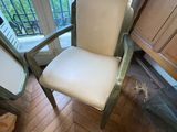 a white chair sitting in front of a window in a room
