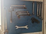 a picture of a bunch of tools hanging on a wall