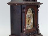 a wooden clock that is sitting on a table