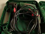 a green box with wires in it on the floor