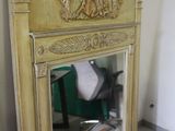 a mirror that is sitting on the floor in front of a fireplace