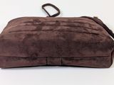a brown purse that is sitting on a white surface