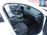 the interior of a car with the door open and the driver ' s seat down