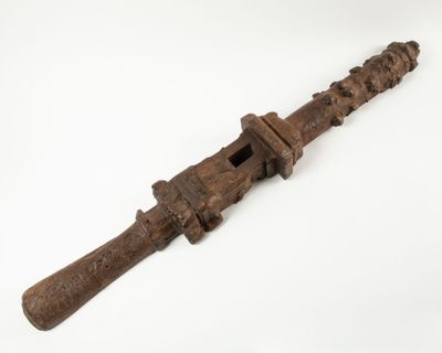 an old wooden knife with a wooden handle on a white surface