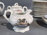 a lot of dishes and cups on the table