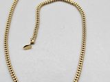 a gold chain with a clasp on a white background