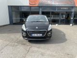 the front of a black car parked in front of a building