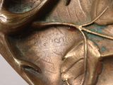 a close up of a bronze sculpture of a face