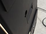 a black television sitting on the floor next to a wall
