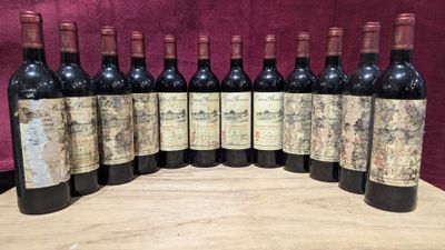 six bottles of wine are lined up on a wooden table