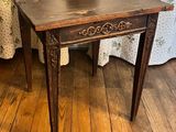 a small table with a wooden top on a wooden floor