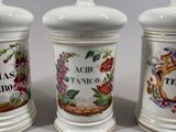 three ceramic jars with different designs on them sitting on a table