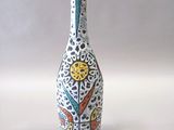 a white vase with a design on it on a table