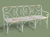 a white bench with a metal frame on a green background