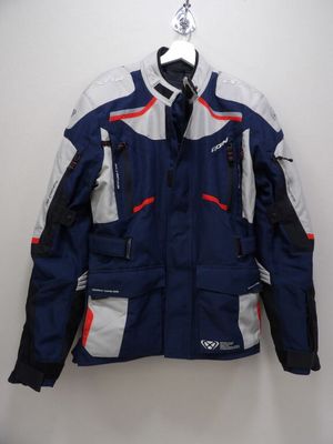 a close up of a jacket on a hanger on a wall