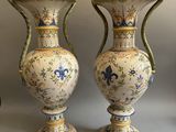 two vases sitting next to each other on a table