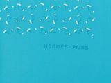 a blue t shirt with white birds on it and the words hermes paris