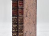 an old book sitting on top of a white surface