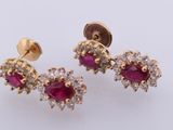 a pair of ruby and diamond earrings