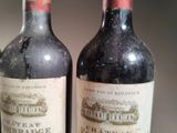 two bottles of wine are sitting on a table next to each other