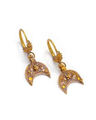 a pair of gold earrings with yellow crystals and a crescent