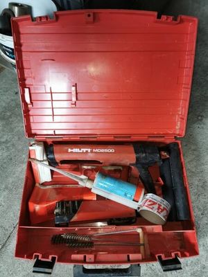 a red tool box with tools in it on the floor
