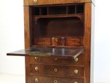 a wooden cabinet with a marble top on a white floor