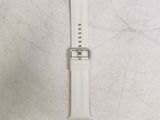 a close up of a watch on a table with a white background