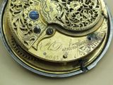 a close up of a gold pocket watch on a table